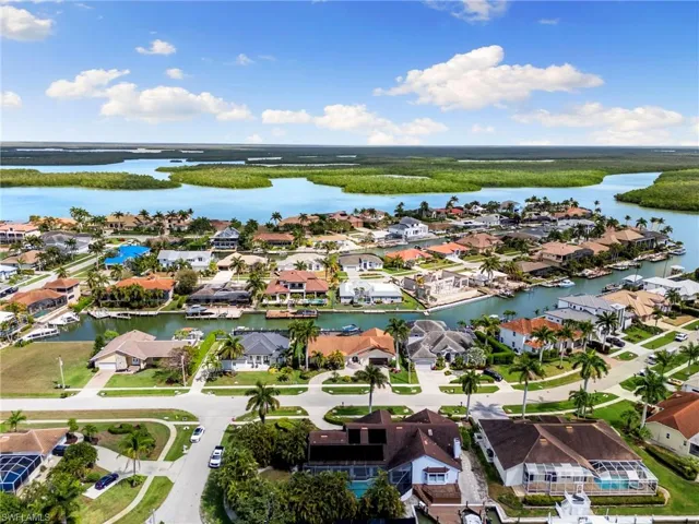 Aerial perspective of suburban area with a nearby body of water