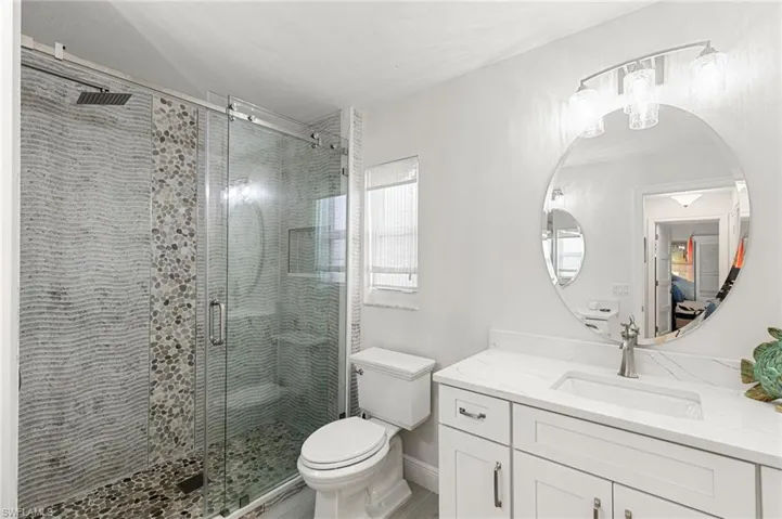 Full bathroom with vanity and a stall shower