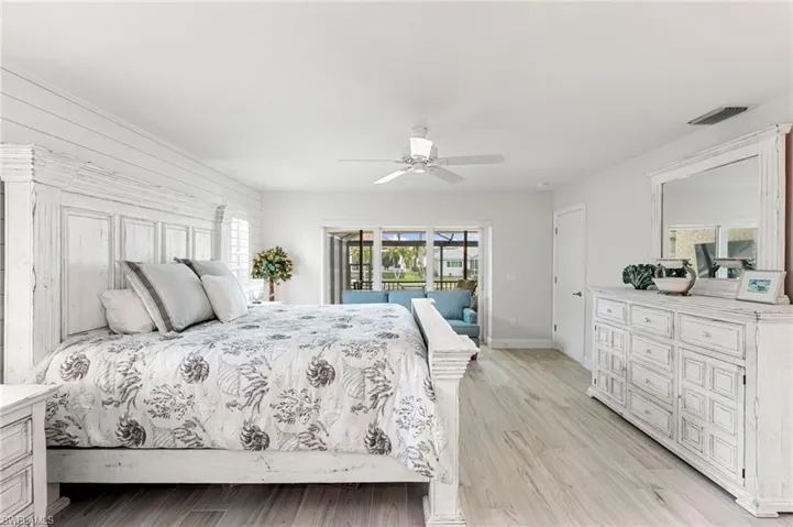 Bedroom with access to exterior, ceiling fan, and light wood-style floors