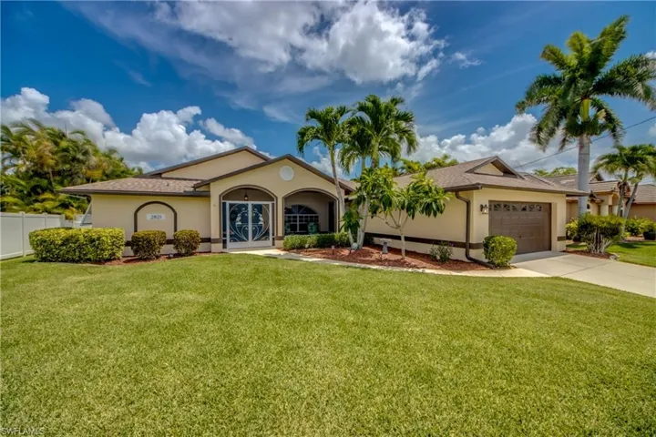View of front of property featuring a garage and a front yard