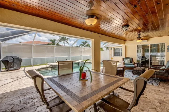 Sunroom / solarium with ceiling fan and wood ceiling