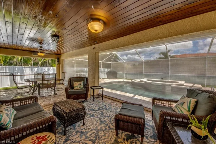Sunroom / solarium featuring wooden ceiling, ceiling fan, and vaulted ceiling