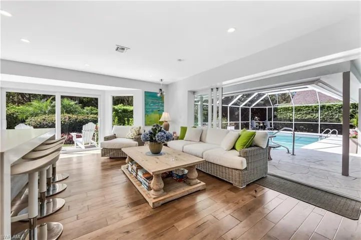 Great room featuring a sunroom, hardwood / wood-style flooring, and recessed lighting