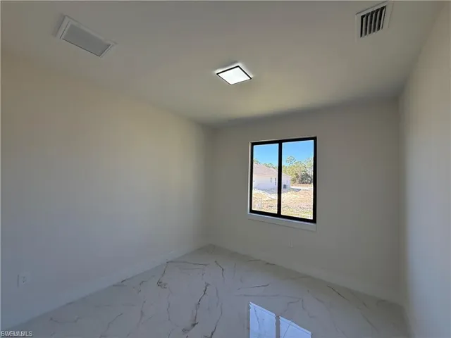 Empty room with baseboards and light marble finish floors