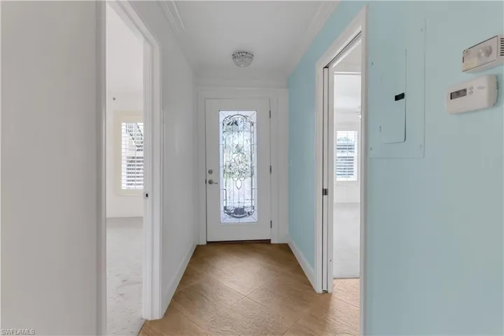 Doorway with electric panel and ornamental molding