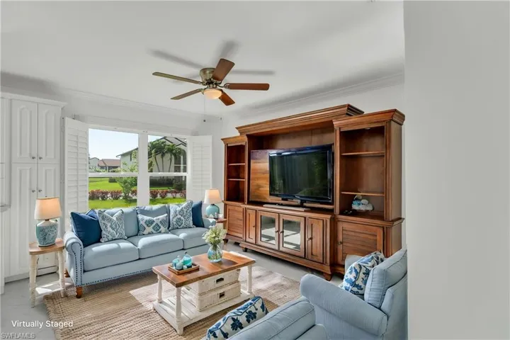 Virtually staged Living room with ornamental molding and a ceiling fan