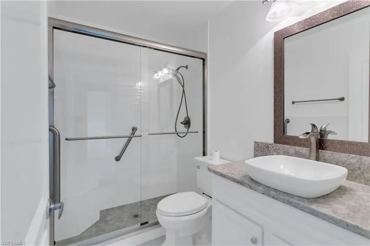 Full bath with vanity and a stall shower