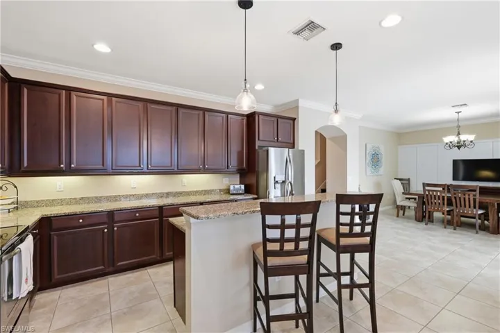 Kitchen featuring wood-finish cabinetry, granite countertops, and stainless steel appliances