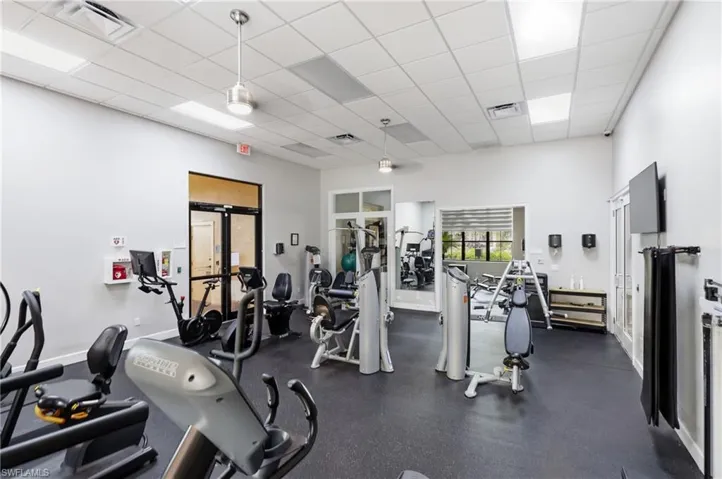 Fitness center featuring a rubberized floor and a variety of exercise equipment