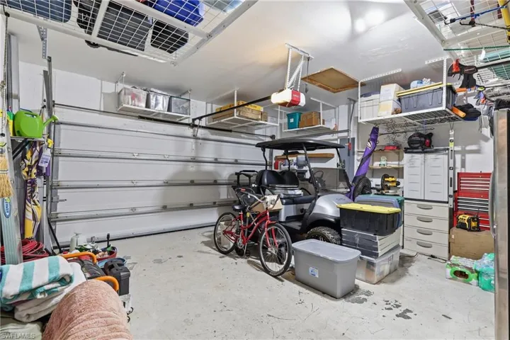 Garage featuring concrete flooring and a white sectional garage door