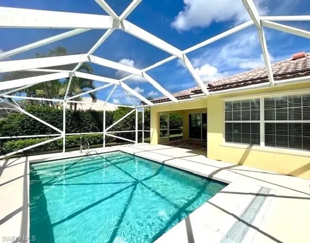 View of pool with a patio and a lanai