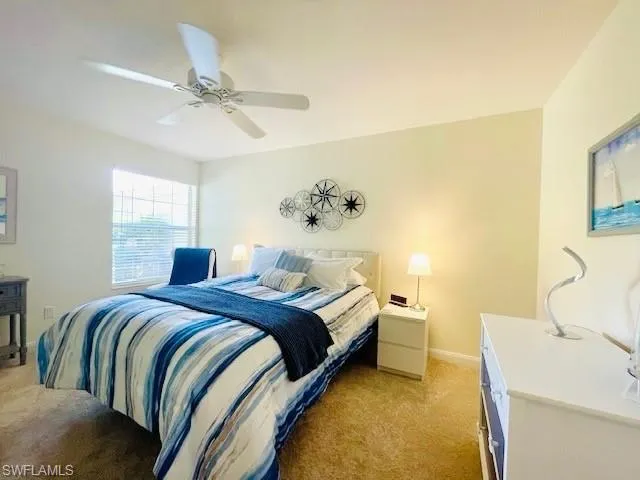 Bedroom featuring ceiling fan and light colored carpet