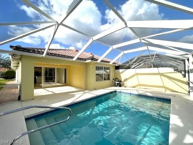 View of swimming pool with a lanai and a patio