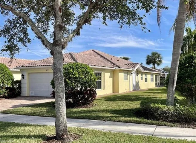 View of front of home featuring a garage and a front yard