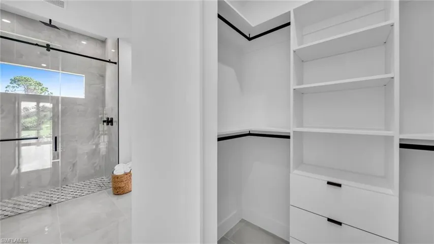 Spacious closet with tile patterned floors