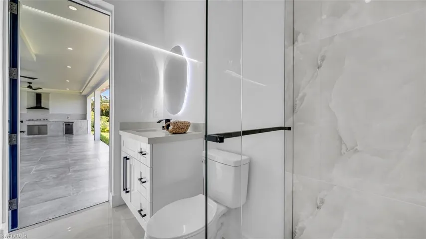 Full bath featuring vanity, recessed lighting, beverage cooler, and a ceiling fan