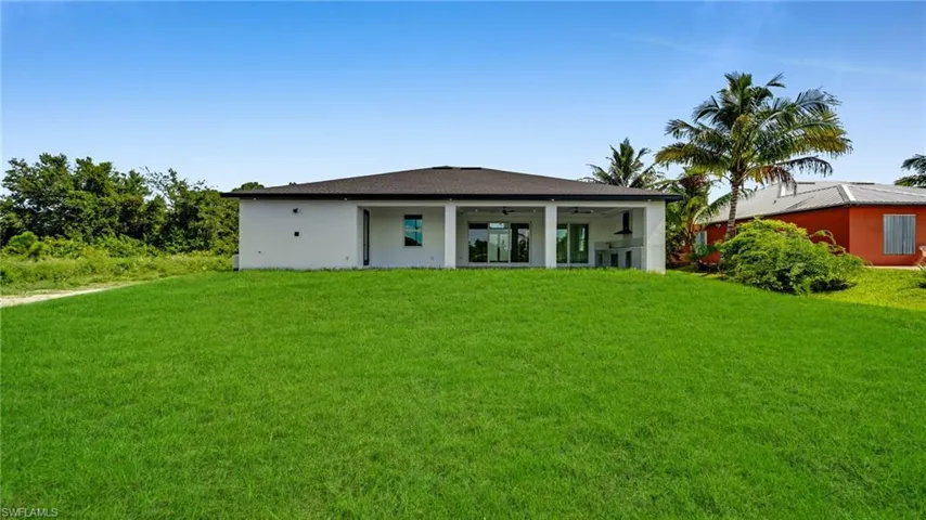 Back of house with a lawn