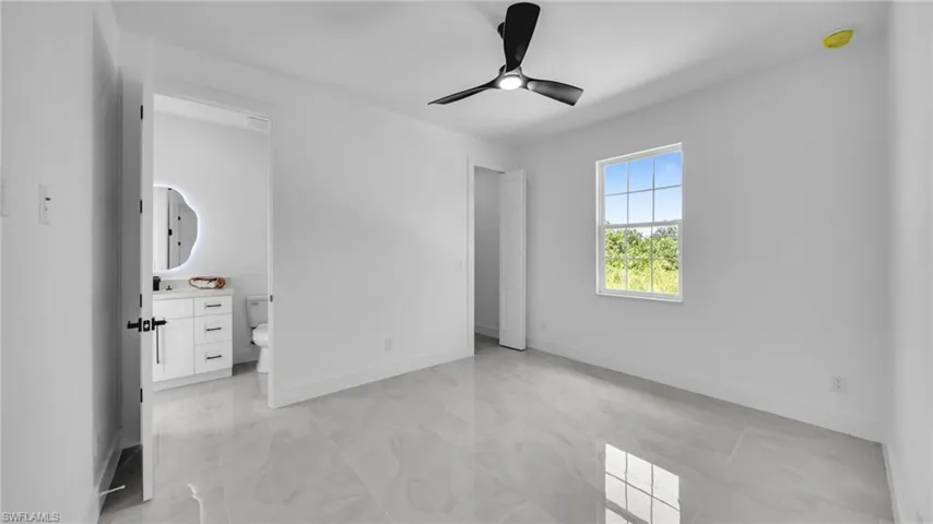 Unfurnished bedroom featuring baseboards and a ceiling fan