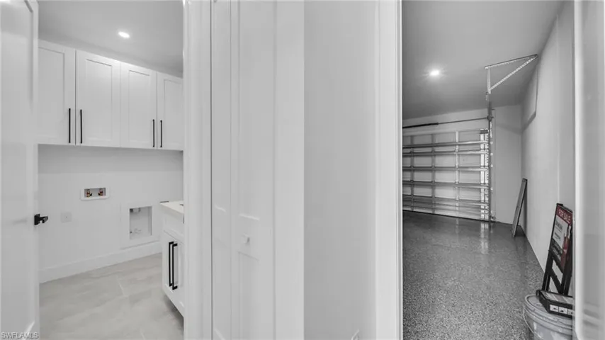 Washroom featuring cabinet space, hookup for a washing machine, a garage, and recessed lighting