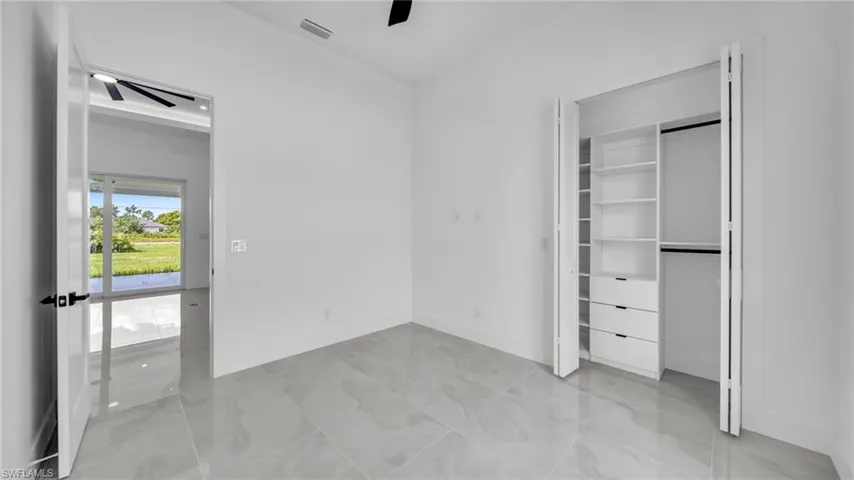 Unfurnished bedroom with baseboards and ceiling fan