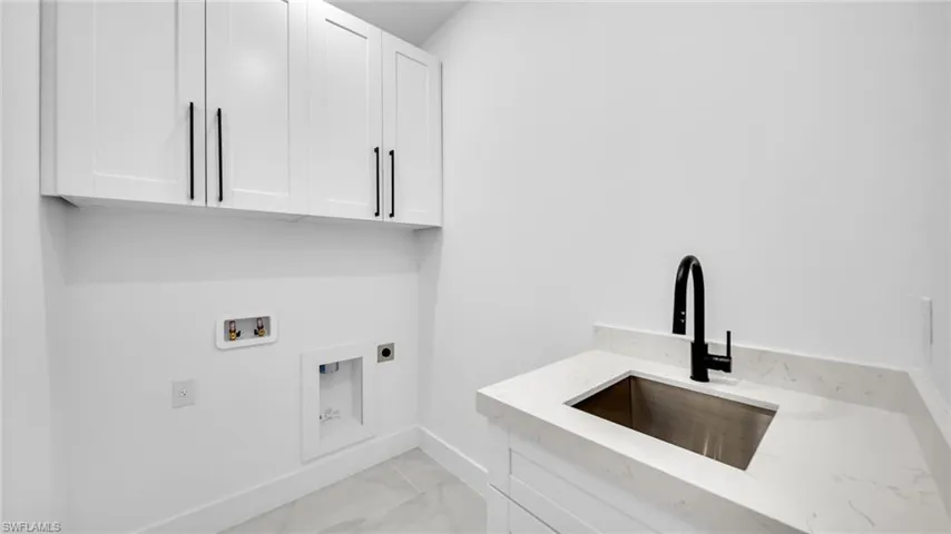 Laundry room featuring hookup for an electric dryer, cabinet space, and hookup for a washing machine