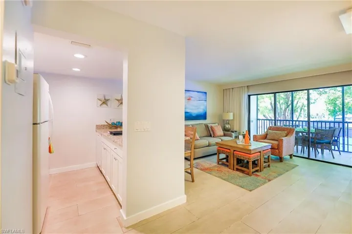 Living area with recessed lighting and light tile patterned flooring