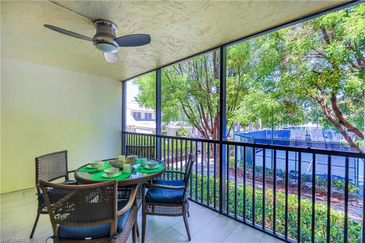 Sunroom / solarium featuring a ceiling fan and a balcony