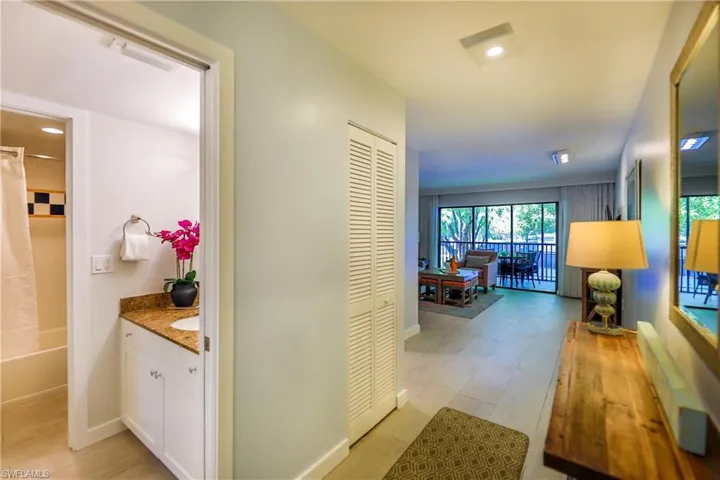 Hallway with baseboards and recessed lighting