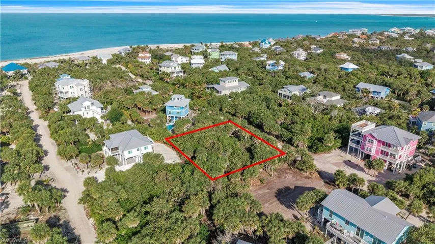 Aerial view of 4521 Oro Pesos Lane (outlined in red) — nestled among established island homes on North Captiva, with the Gulf of Mexico visible just steps away.