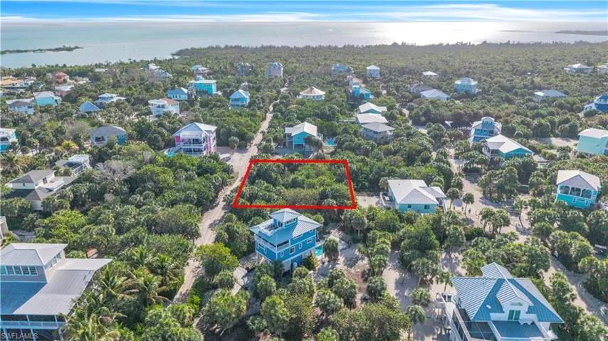 Aerial view of 4521 Oro Pesos Lane (outlined in red) — nestled among established island homes on North Captiva, with the Gulf of Mexico visible just steps away.