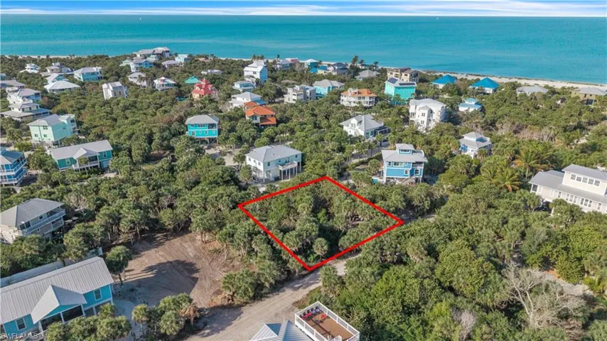 Aerial view of 4521 Oro Pesos Lane (outlined in red) — nestled among established island homes on North Captiva, with the Gulf of Mexico visible just steps away.