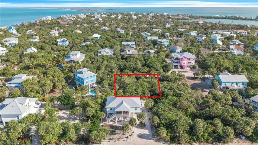 Aerial view of 4521 Oro Pesos Lane (outlined in red) — nestled among established island homes on North Captiva, with the Gulf of Mexico visible just steps away.
