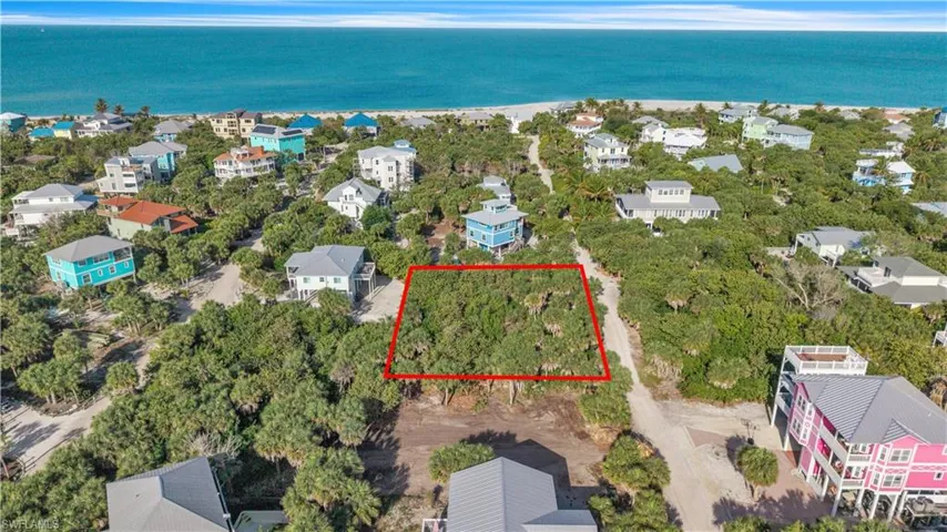 Aerial view of 4521 Oro Pesos Lane (outlined in red) — nestled among established island homes on North Captiva, with the Gulf of Mexico visible just steps away.