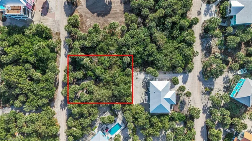Aerial view of 4521 Oro Pesos Lane (outlined in red) — nestled among established island homes on North Captiva, with the Gulf of Mexico visible just steps away.
