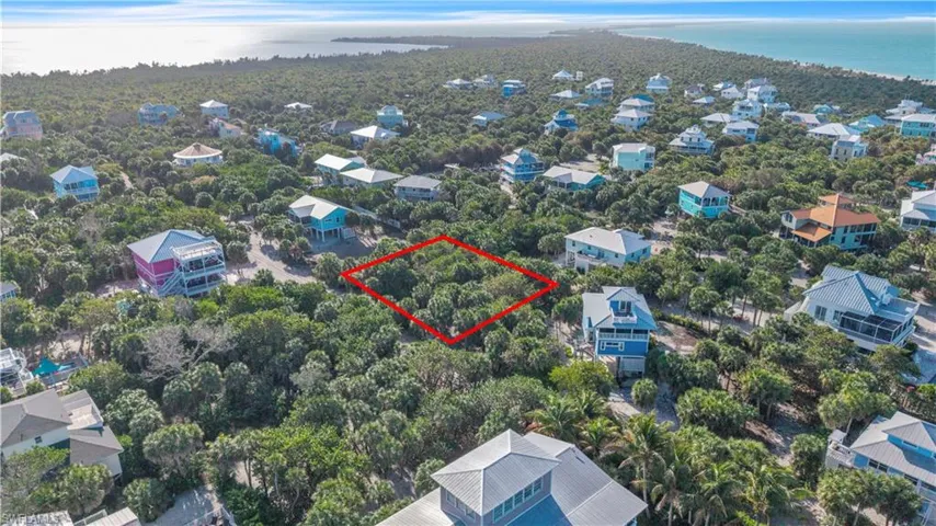 Aerial view of 4521 Oro Pesos Lane (outlined in red) — nestled among established island homes on North Captiva, with the Gulf of Mexico visible just steps away.