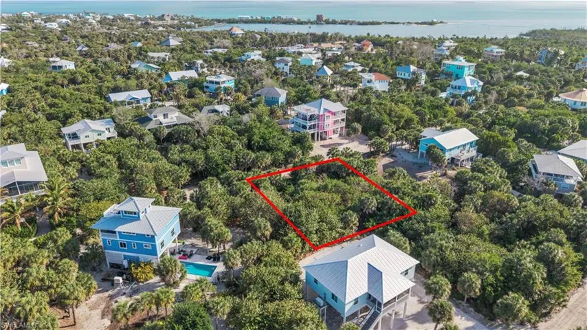 Aerial view of 4521 Oro Pesos Lane (outlined in red) — nestled among established island homes on North Captiva, with the Gulf of Mexico visible just steps away.