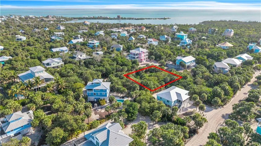 Aerial view of 4521 Oro Pesos Lane (outlined in red) — nestled among established island homes on North Captiva, with the Gulf of Mexico visible just steps away.