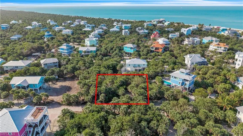 Aerial view of 4521 Oro Pesos Lane (outlined in red) — nestled among established island homes on North Captiva, with the Gulf of Mexico visible just steps away.