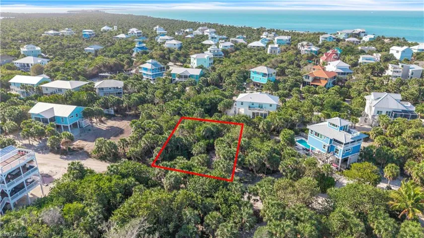 Aerial view of 4521 Oro Pesos Lane (outlined in red) — nestled among established island homes on North Captiva, with the Gulf of Mexico visible just steps away.