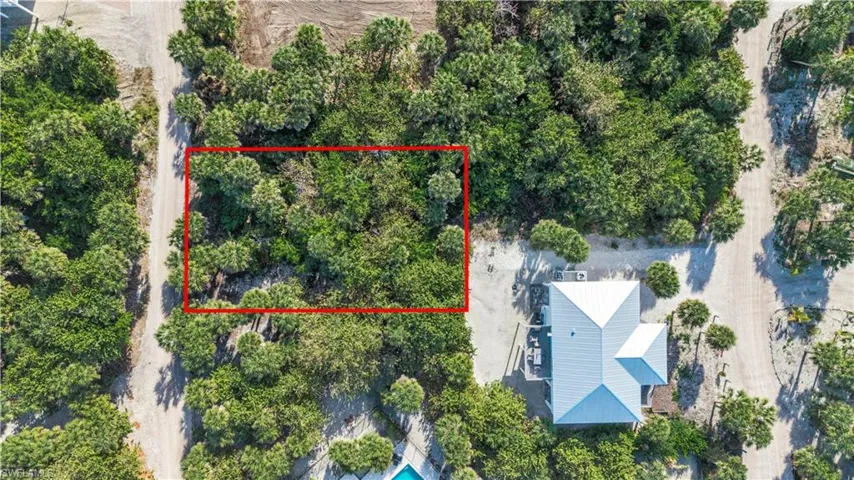 Aerial view of 4521 Oro Pesos Lane (outlined in red) — nestled among established island homes on North Captiva, with the Gulf of Mexico visible just steps away.