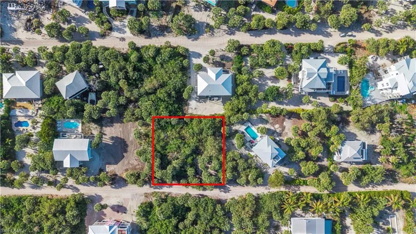 Aerial view of 4521 Oro Pesos Lane (outlined in red) — nestled among established island homes on North Captiva, with the Gulf of Mexico visible just steps away.