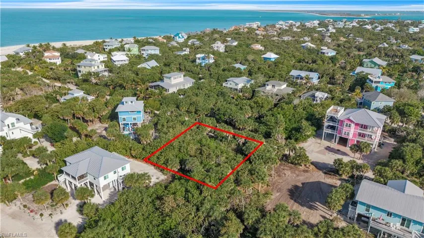 Aerial view of 4521 Oro Pesos Lane (outlined in red) — nestled among established island homes on North Captiva, with the Gulf of Mexico visible just steps away.