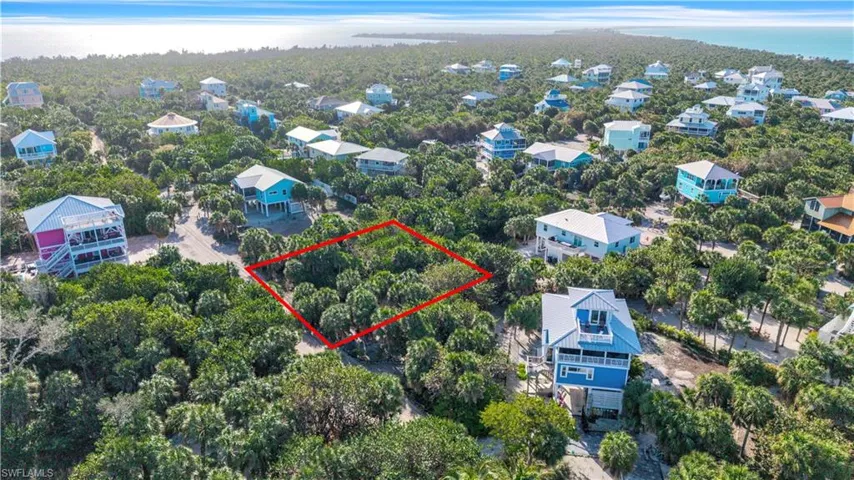 Aerial view of 4521 Oro Pesos Lane (outlined in red) — nestled among established island homes on North Captiva, with the Gulf of Mexico visible just steps away.