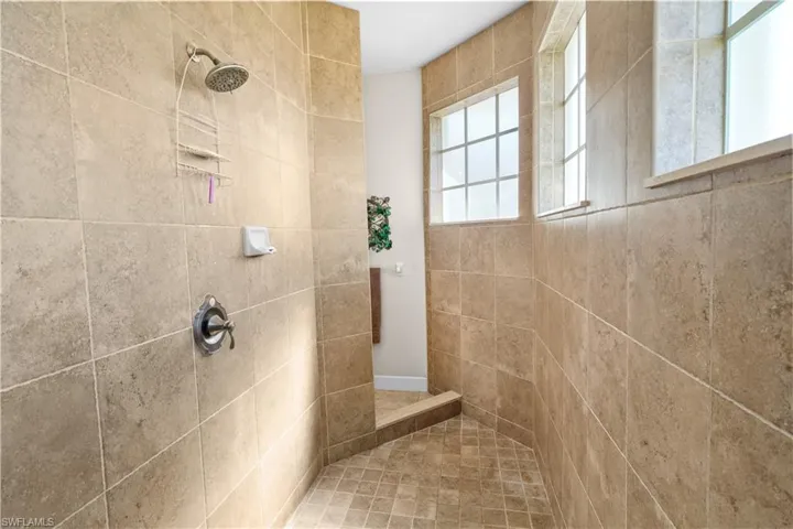 Beautiful walk-through shower featuring floor to ceiling tile and lots of natural light.