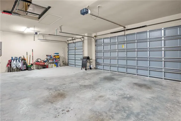 3 car garage with hurricane rated garage doors, automatic garaage door openers, pulldown stairs to the attic. The 2 air handlers for the A/C are also built into a cove in the garage ceiling.