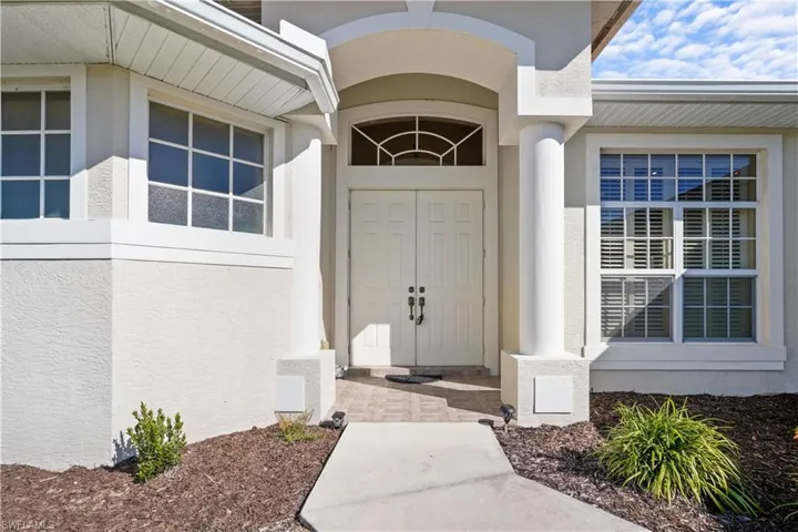 DOuble door entry with column nicely landscaped. The home has a nice curb appeal just waiting for your personal touches.