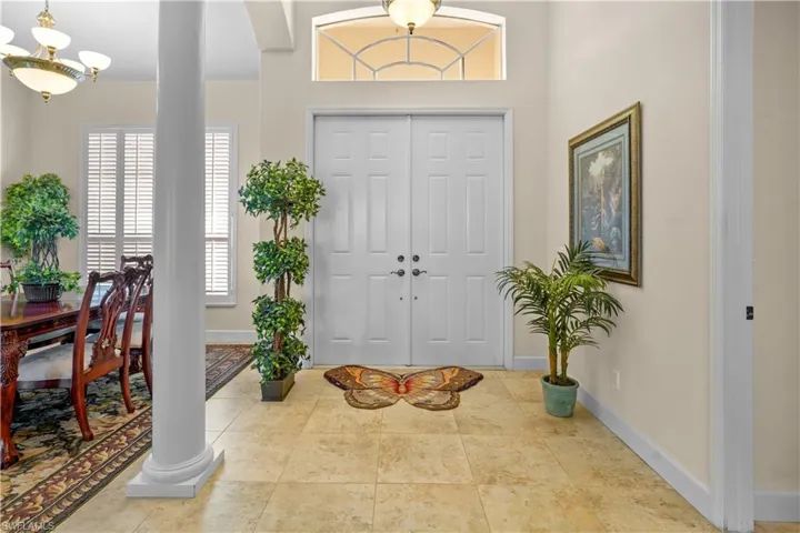 Entrance foyer with a chandelier and tile 20"  porcelain tile floors. Opens to the amazing great room.