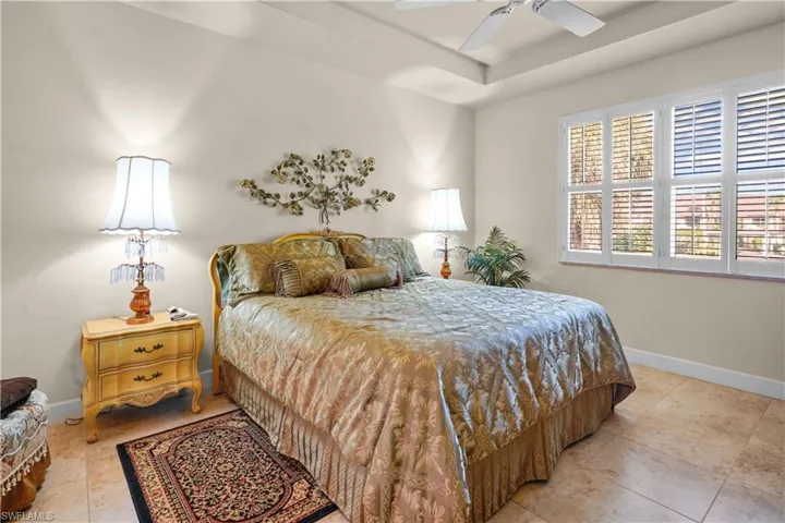 Spacious primay bedroom that is 20' x 13' with nice natural lighting from hurricane windows with plantation shutters. High trayed ceiling, 20" porcelain tile, 5 3/4' base board and ceiling fan.