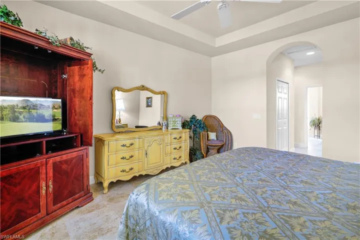 Bedroom with arched walkways, to the enterance and primary bath room, two walk-in closets.