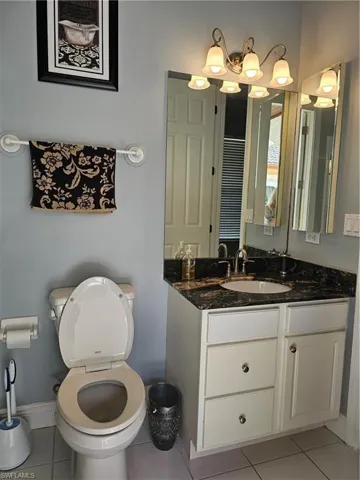 Bathroom featuring light tile patterned floors and vanity